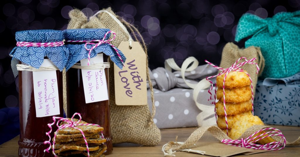 A selection of homemade treats, including cookies and jams, wrapped up and ready to give as Christmas presents.