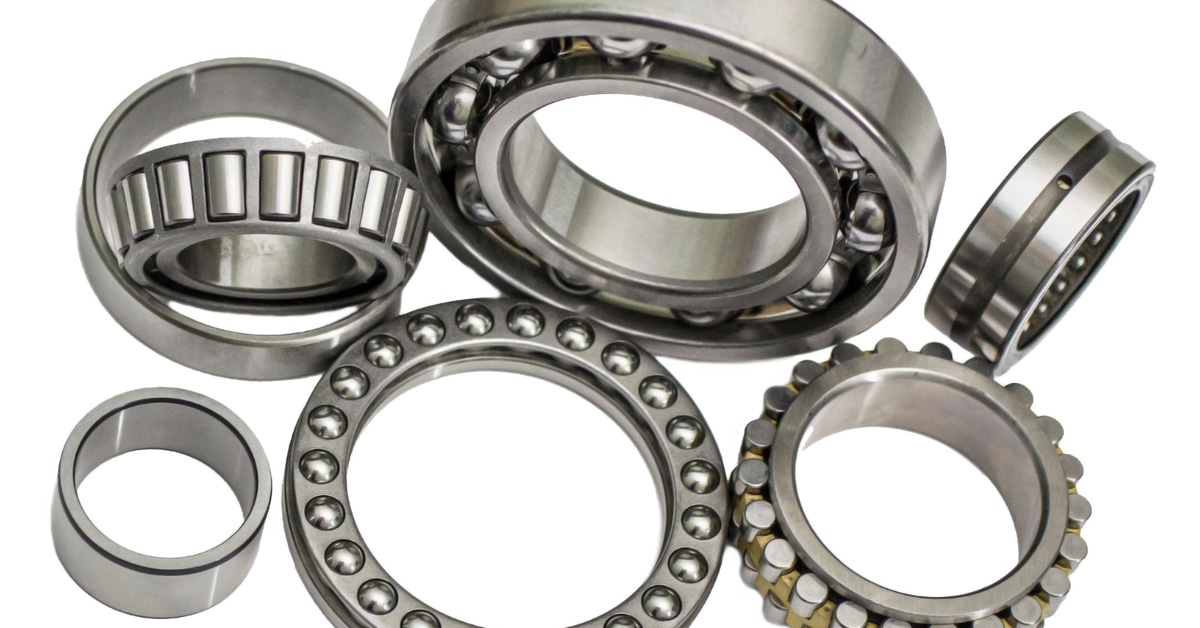 Several Babbitt bearings sit on a white background. Some of them are lying flat, and others are sitting up.